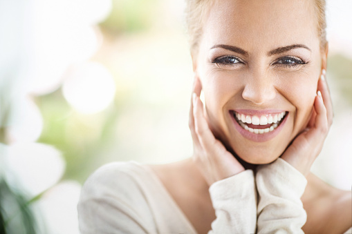 Woman smiling after learning more about cosmetic dentistry at Excellent Dental Specialists.