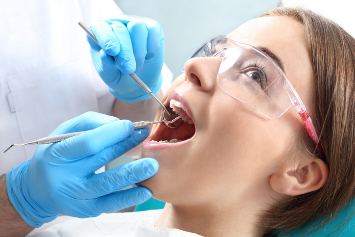 Young woman getting dental cleaning at Excellent Dental Specialists located in San Antonio, TX.