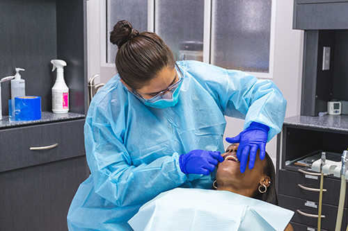 San Antonio cosmetic dentist examing a patients gums at Excellent Dental Specialists.