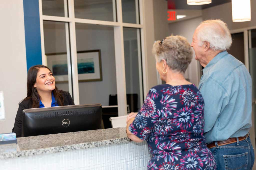 front desk staff greeting patients